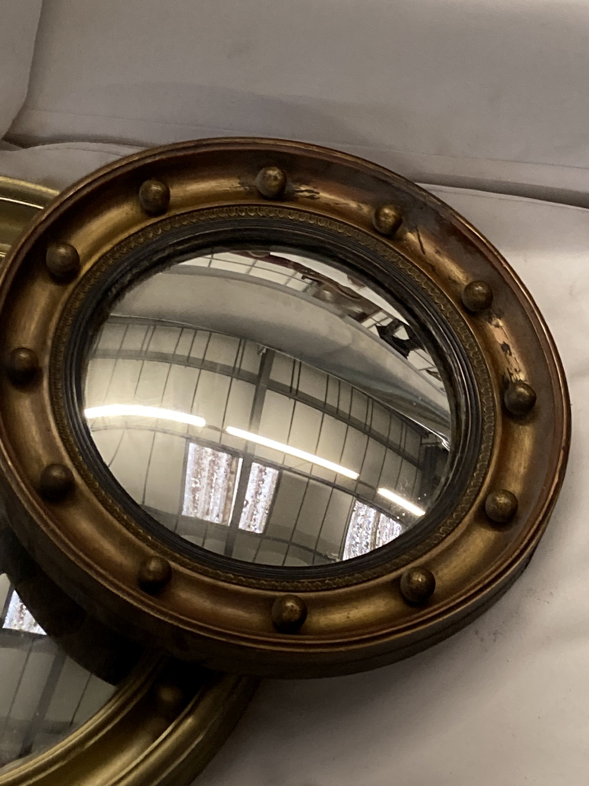 Six circular gilt and brass framed convex wall mirrors, largest 39cm diameter